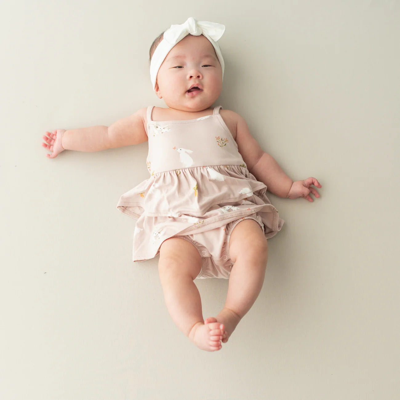 Kyte Baby Spaghetti Strap Ruffle Romper in Blush Rabbit